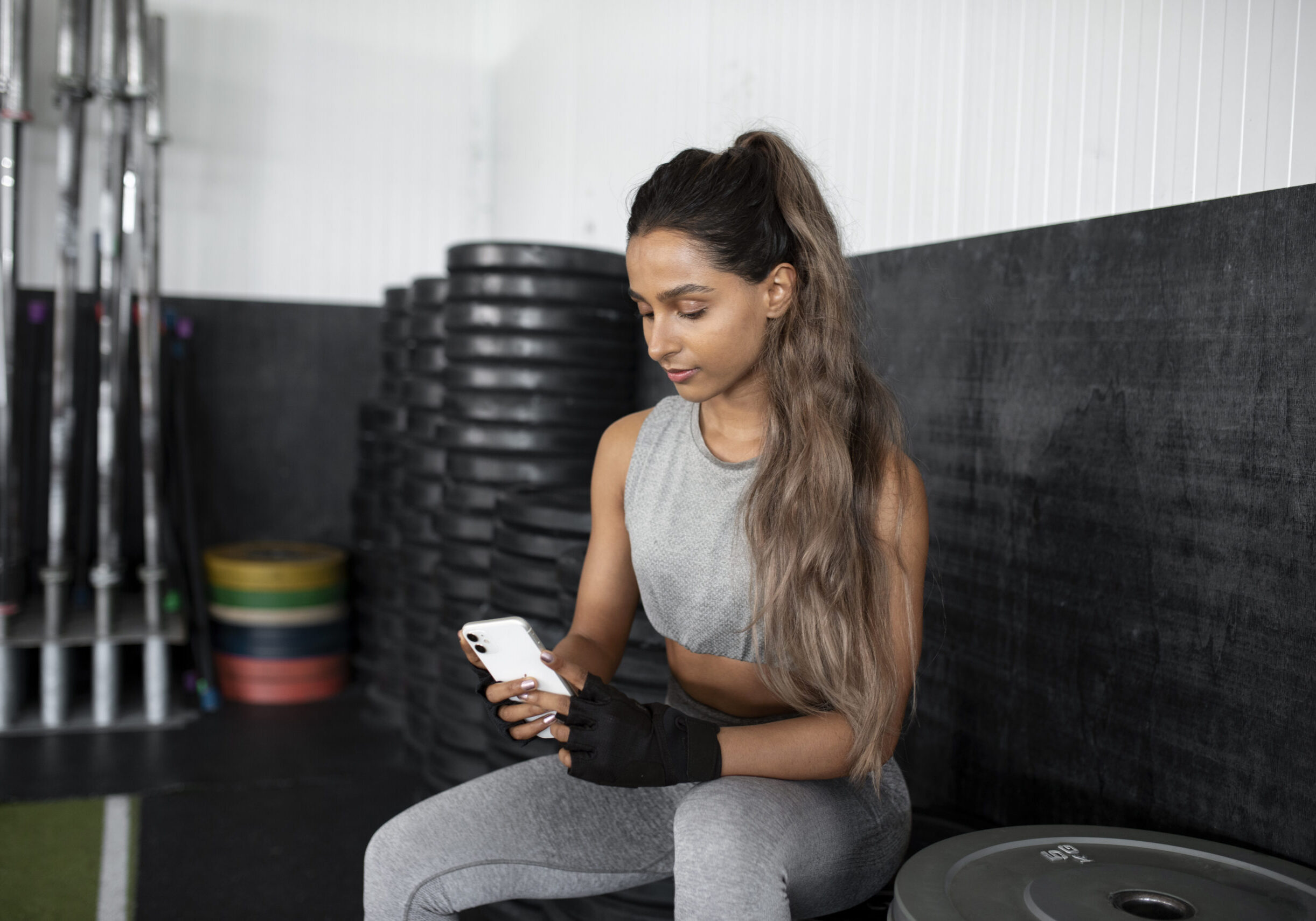 medium-shot-woman-holding-smartphone